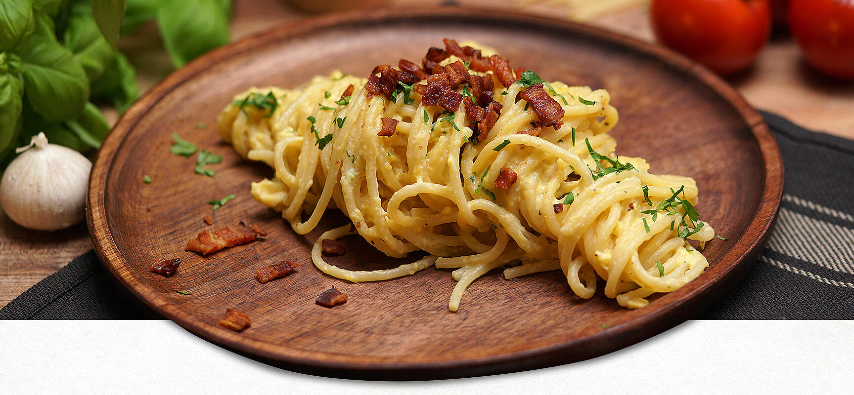 Authentic Spaghetti Carbonara on a wooden plate