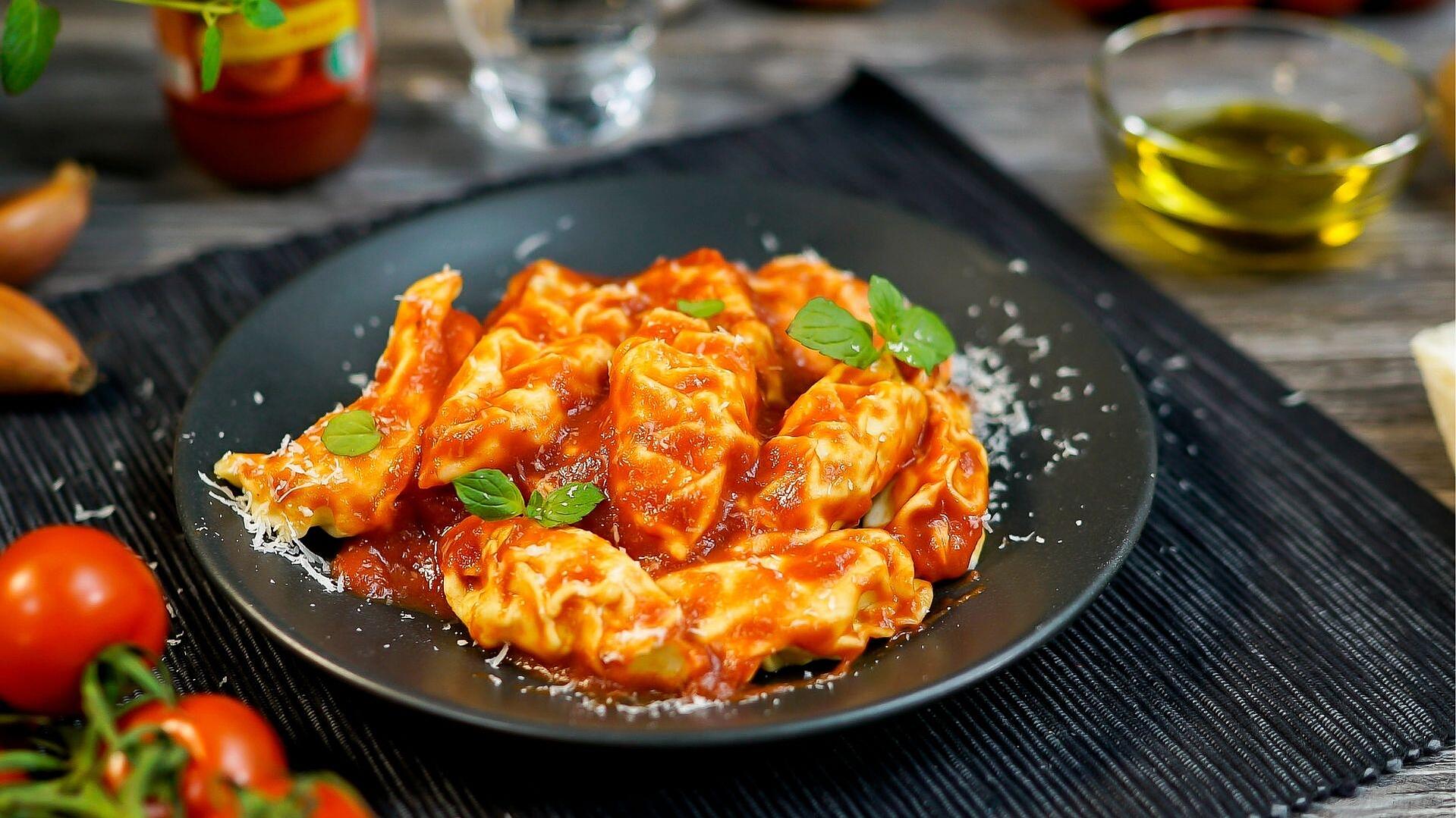 Ein Teller mit Culurgiones - sardischen Ravioli in Tomatensauce